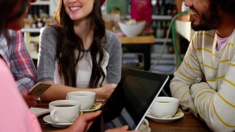 friends interacting while having coffee