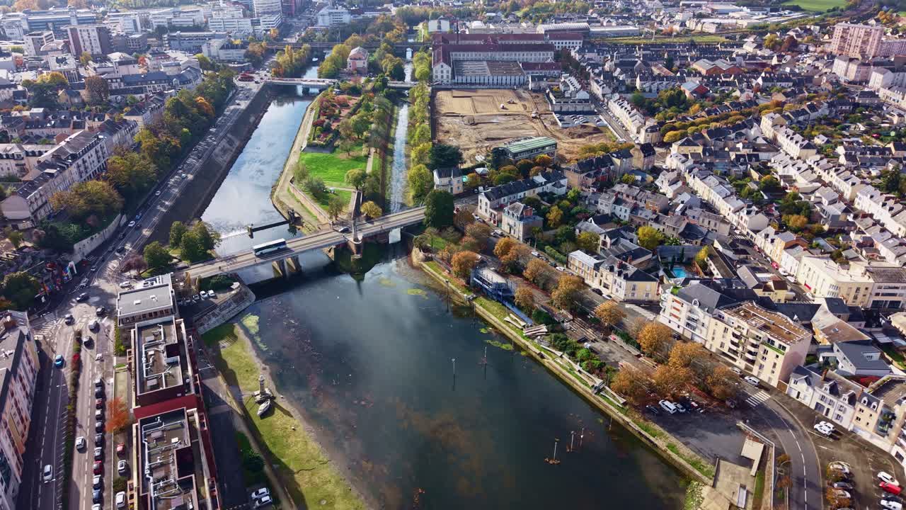 Le Mans cityscape, Sarthe river, Pont de Fer bridge, and historic city architecture, for travel and urban content. Aerial drone forward