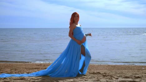 pregnant model in blue dress flying on wind. romantic photo session