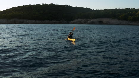 silhouette of man tourist kayaking on scenic beach near city of pula, istrian coast, croatia