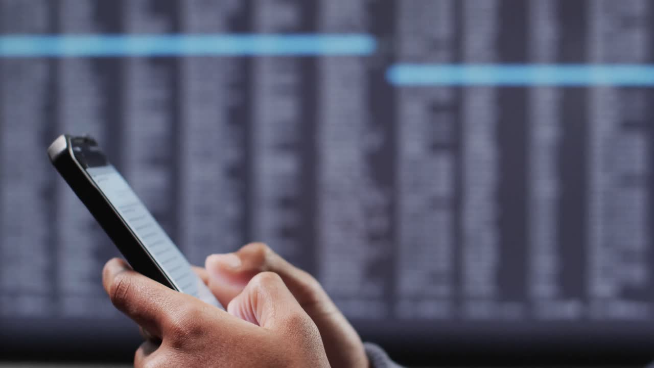 Video of biracial businessman using smartphone with data processing in background