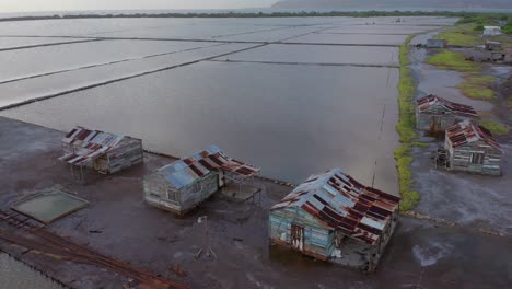 Slow-flight-bull-back-in-a-salt-mine-in-Bani,-Dominican-Republic,-view-of-the-rail-of-the-wagons-where-they-transport-the-extracted-mineral