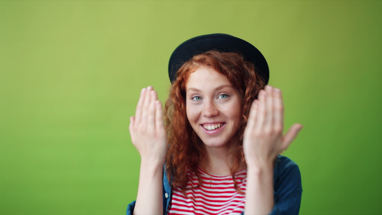 Young Woman with Red Hair and a Black Hat, Expressing Surprise