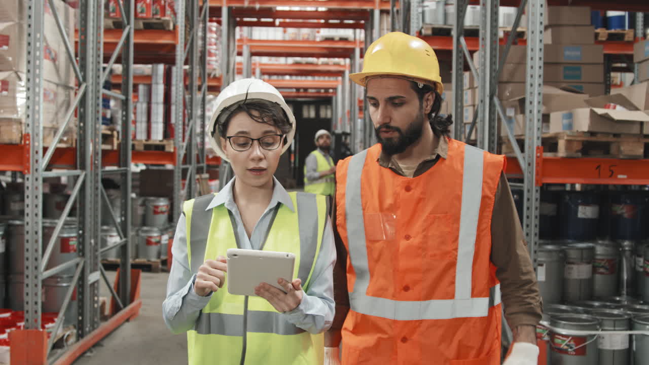 Warehouse Supervisor and Colleague Walking and Talking