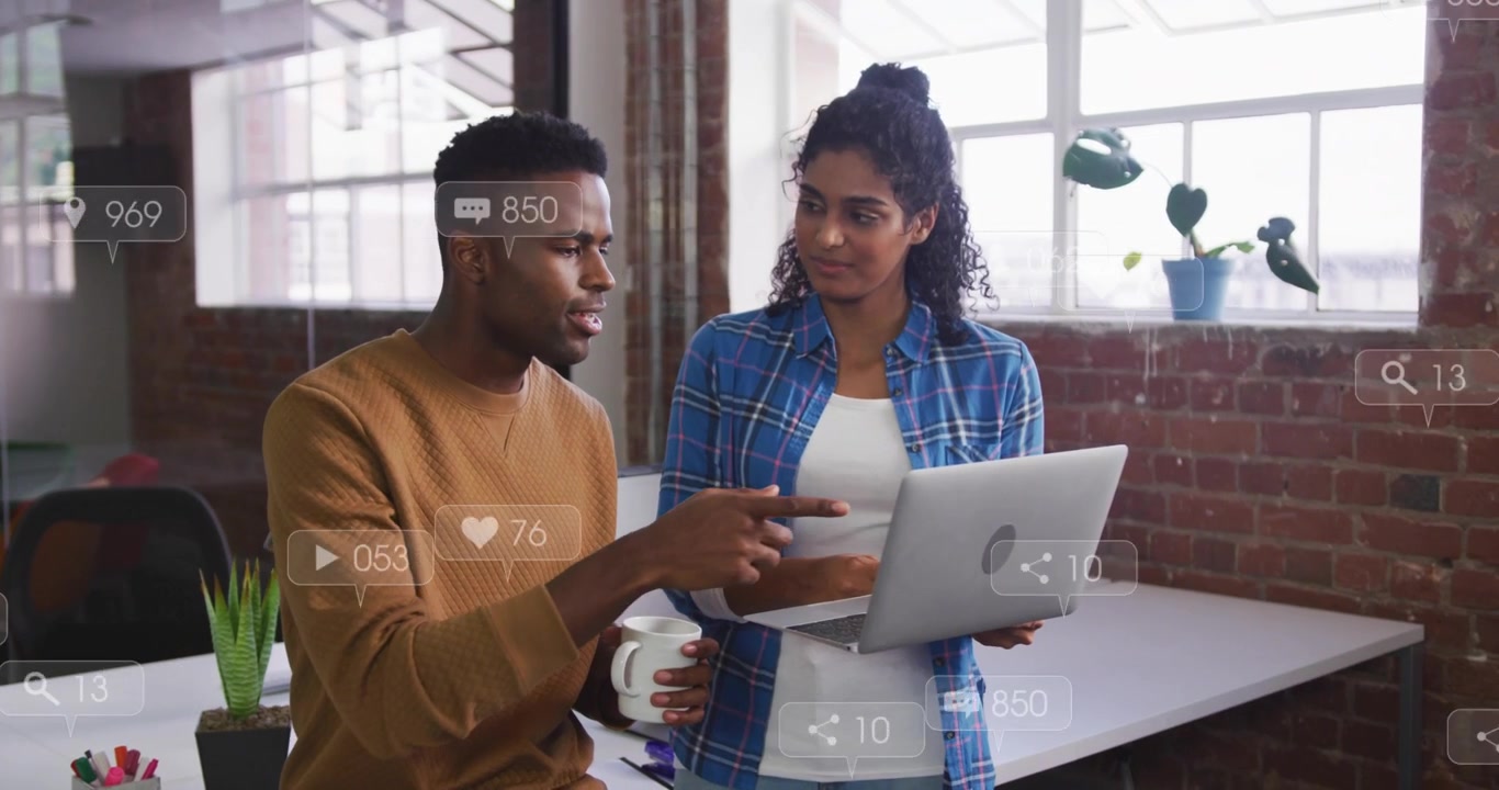 Woman turning laptop to man, colleagues analyzing marketing metrics with floating UI overlays