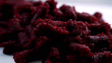 extreme close up of beet pulp spinning on a rotating plate to make chocolate muffins vegan vegetarian cake