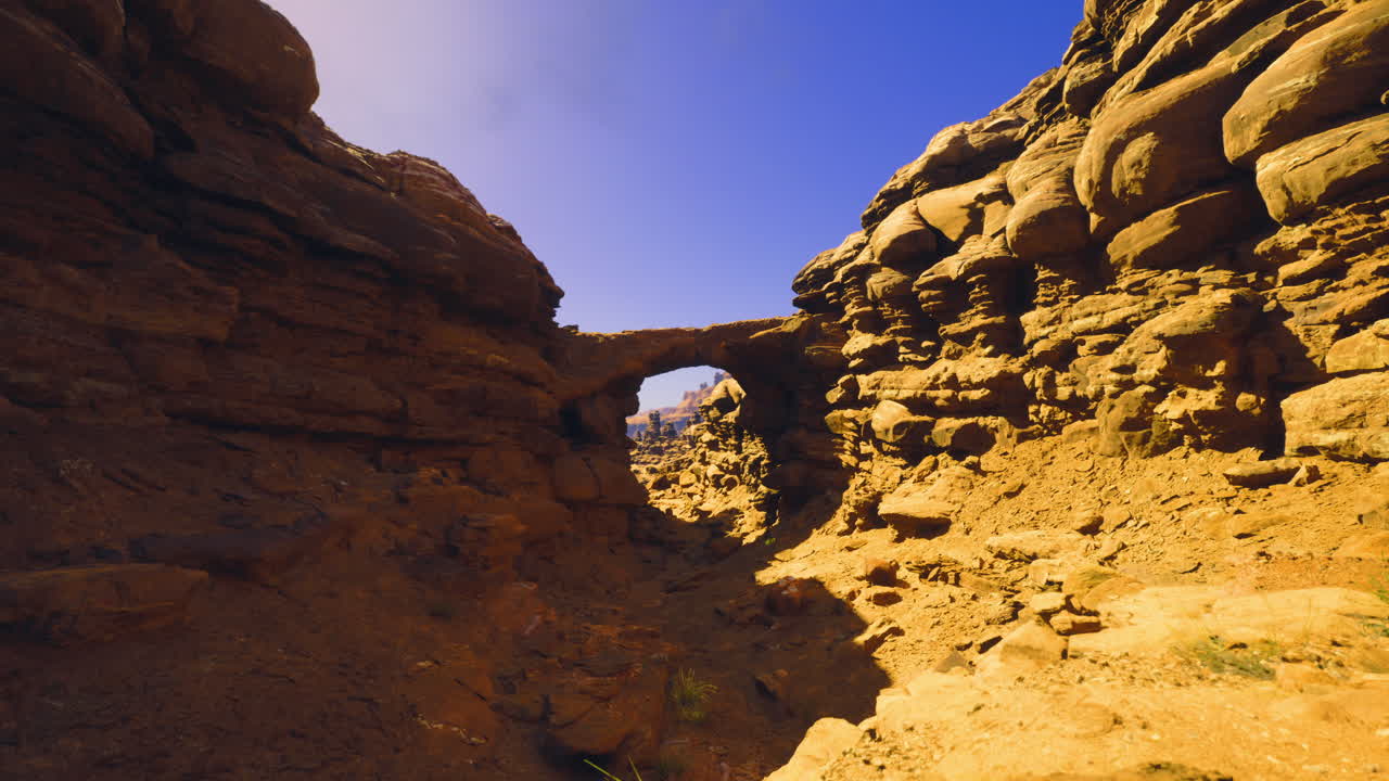 Stunning rock arch formation in a desert landscape under clear blue sky