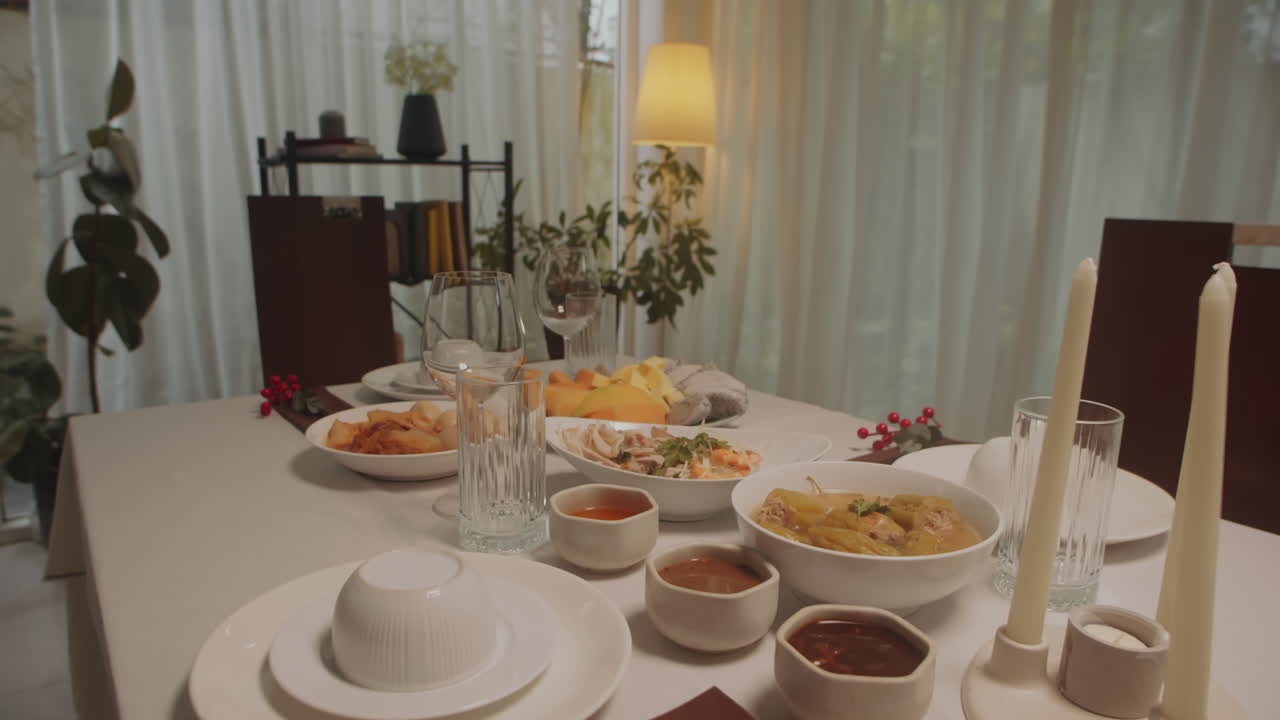 Dishes, Candles and Glasses on Christmas Table