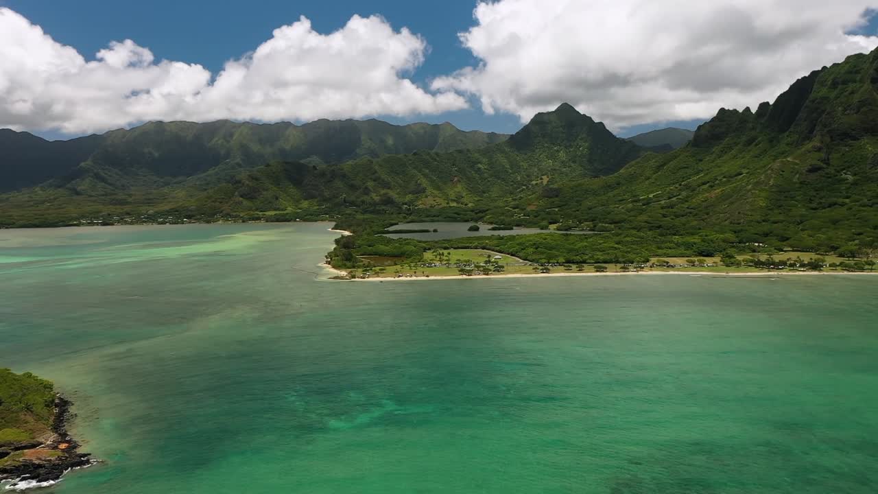 A breathtaking Hawaii ocean drone video capturing endless turquoise waters, gentle waves, coral reefs, and the tropical coastline bathed in golden sunlight, showcasing the serene beauty of islands