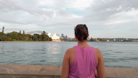 Ethnic-Woman-Looking-At-The-View-Of-Sydney-Opera-House-And-Harbour-Bridge-In-Australia---close-up,-back-view