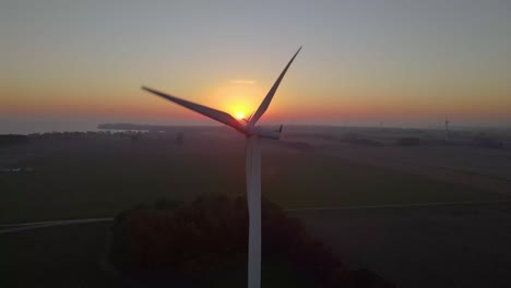 wind energy generator spinning during an amazing sunset or sunrise, close up
