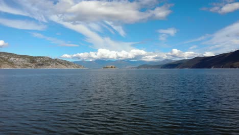 Vibrant-water-surface-of-Prespa-lake-and-mountains-background-at-a-cloudy-day