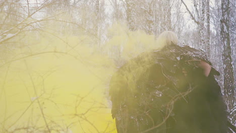 model in phoenix costume walks through yellow smoke backside