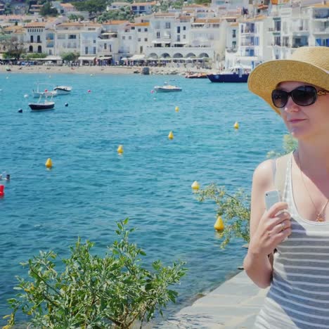 A-woman-rests-by-the-sea-near-Cadaques-in-Catalonia-6