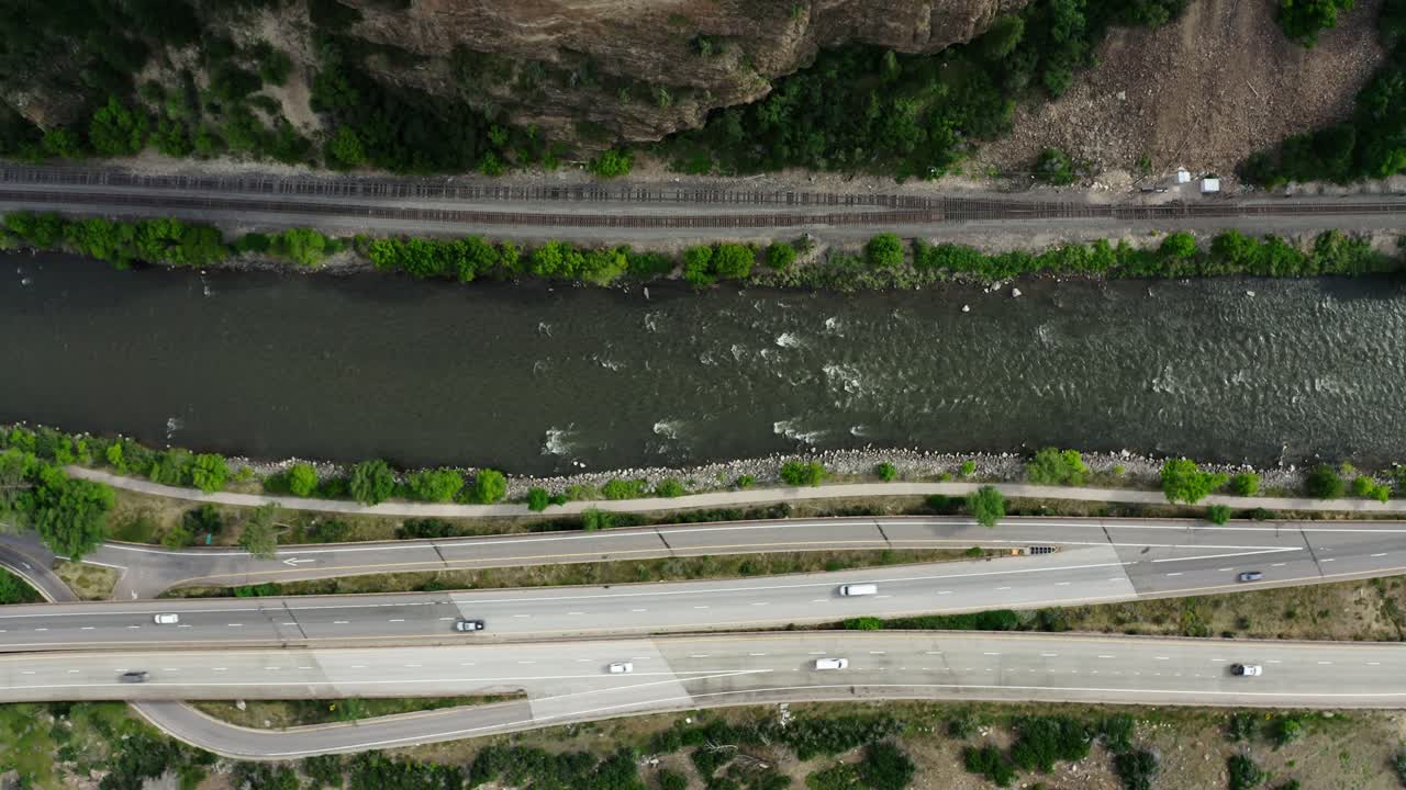Rising top down view of the Colorado River running alongside Interstate 70