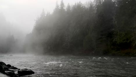 calm water flowing with fog at snoqualmie river in king county, washington