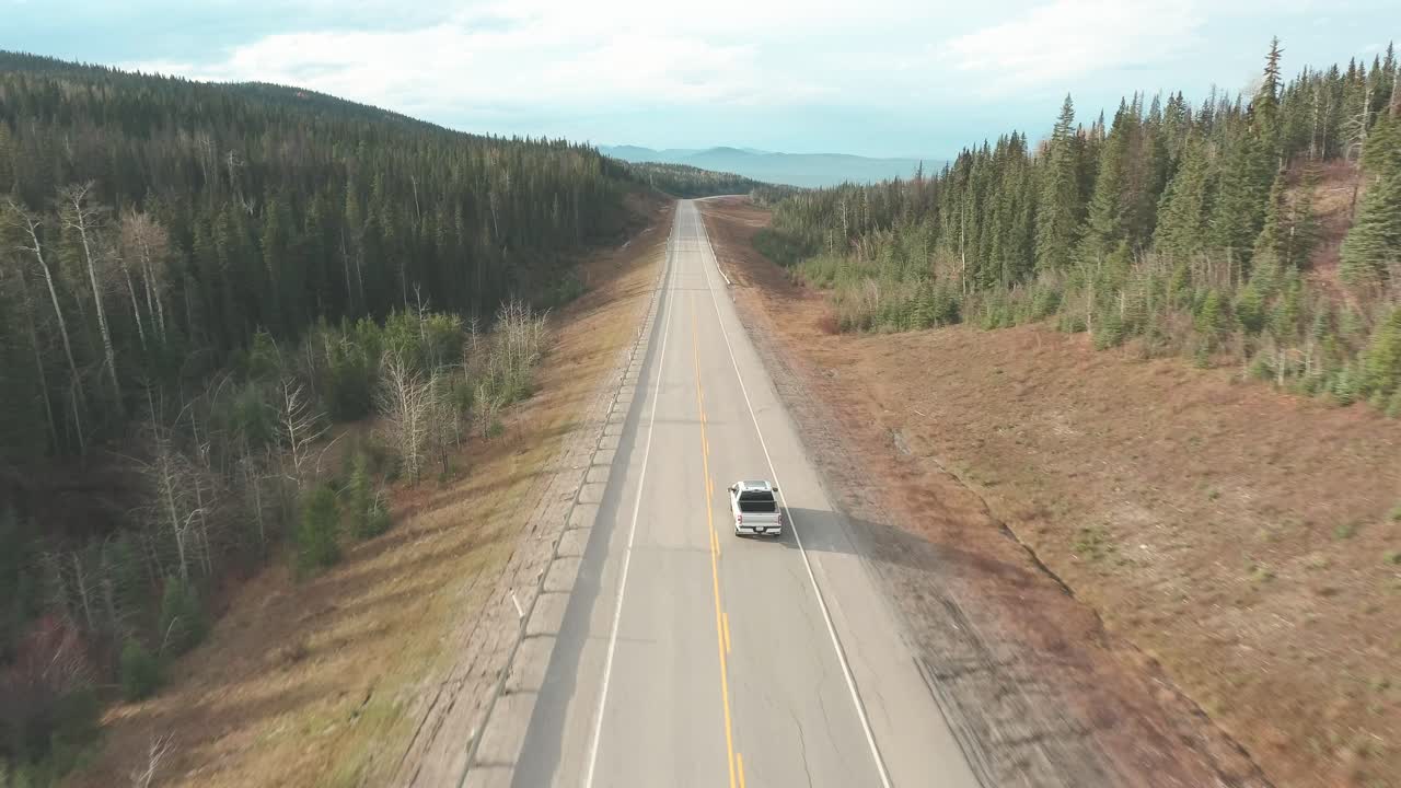Panoramic shot of a truck on the road with a beautiful background