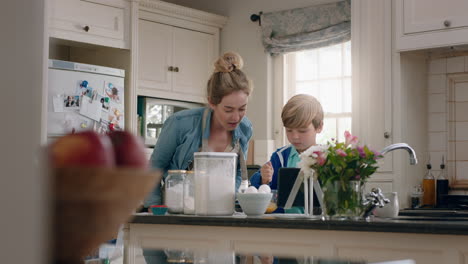 little boy helping mother bake in kitchen mixing ingredients baking cookies preparing recipe at home with mom teaching her son on weekend
