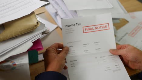 close up of a man opening debt letters