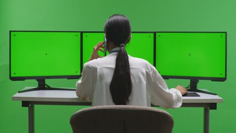 트리플 모니터 설정에서 일하는 여성