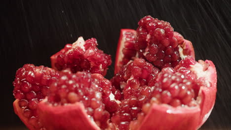 close-up of a sliced pomegranate with water droplets