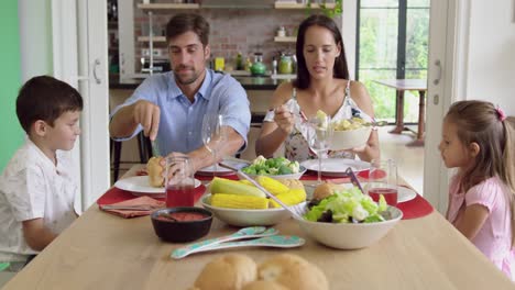 Family-having-meal-together-on-dinning-table-at-home-4k