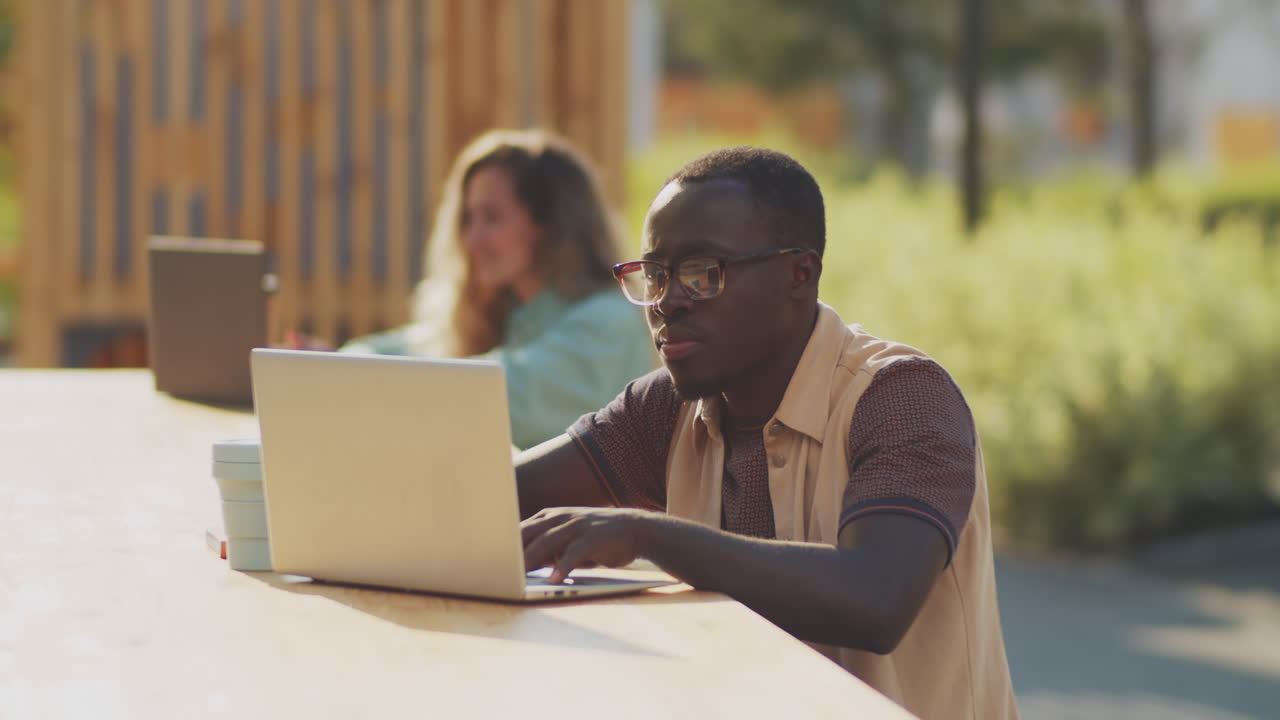 African American Freelancer Working on Laptop in Park