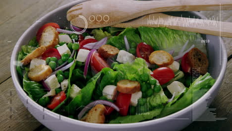 fresh salad with tomatoes, croutons, and feta over data processing animation