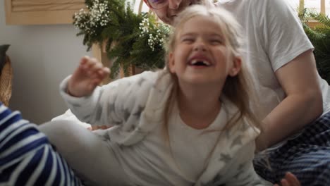 family spending christmas morning together in bed