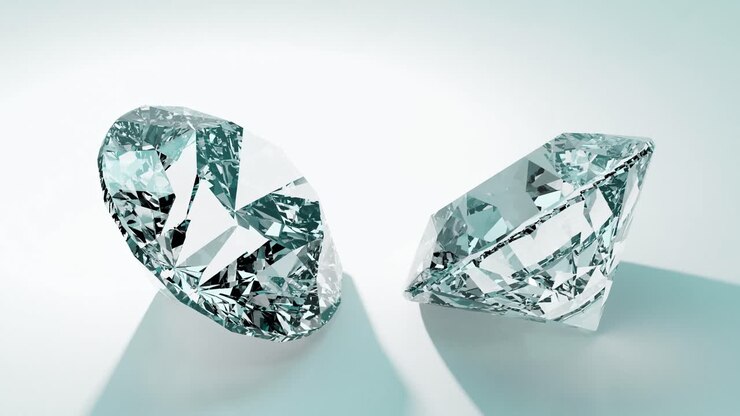 Due diamanti scintillanti che riflettono la luce su sfondo blu