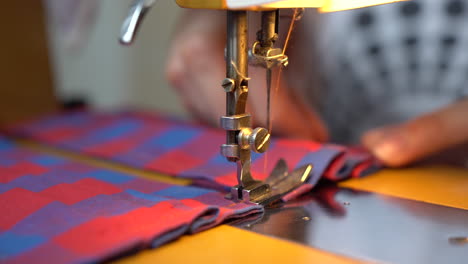 woman making a homemade mask from fabric with a sewing machine