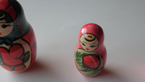 three colorful russian matryoshka dolls lined up on a white surface with intricate patterns