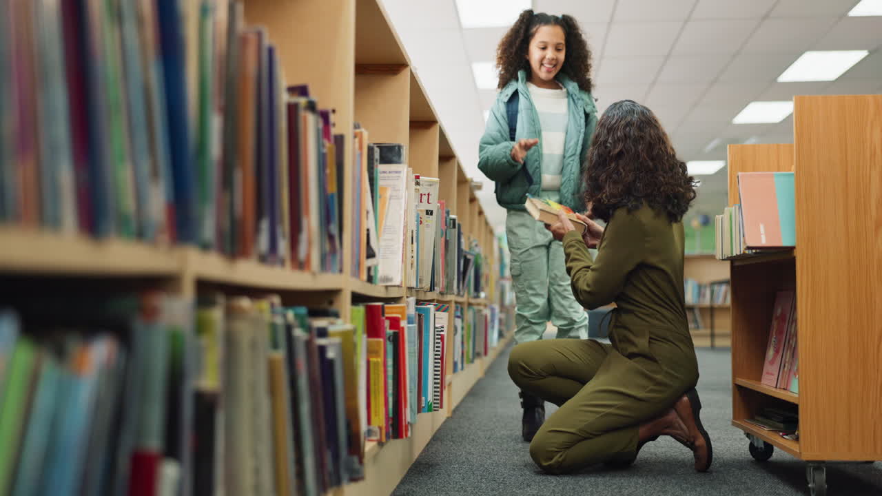 Young girl getting a high five from librarian in a library