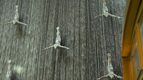 waterfall with sculptures of divers in a mall