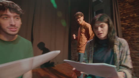 drama actors performing roles on theater rehearsal with stage director
