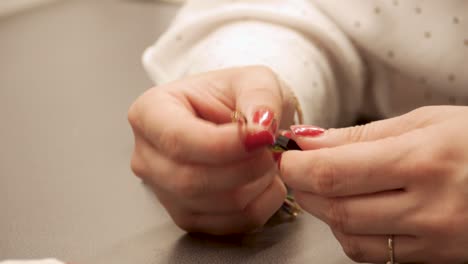 women's hands assembling an electrical component in production