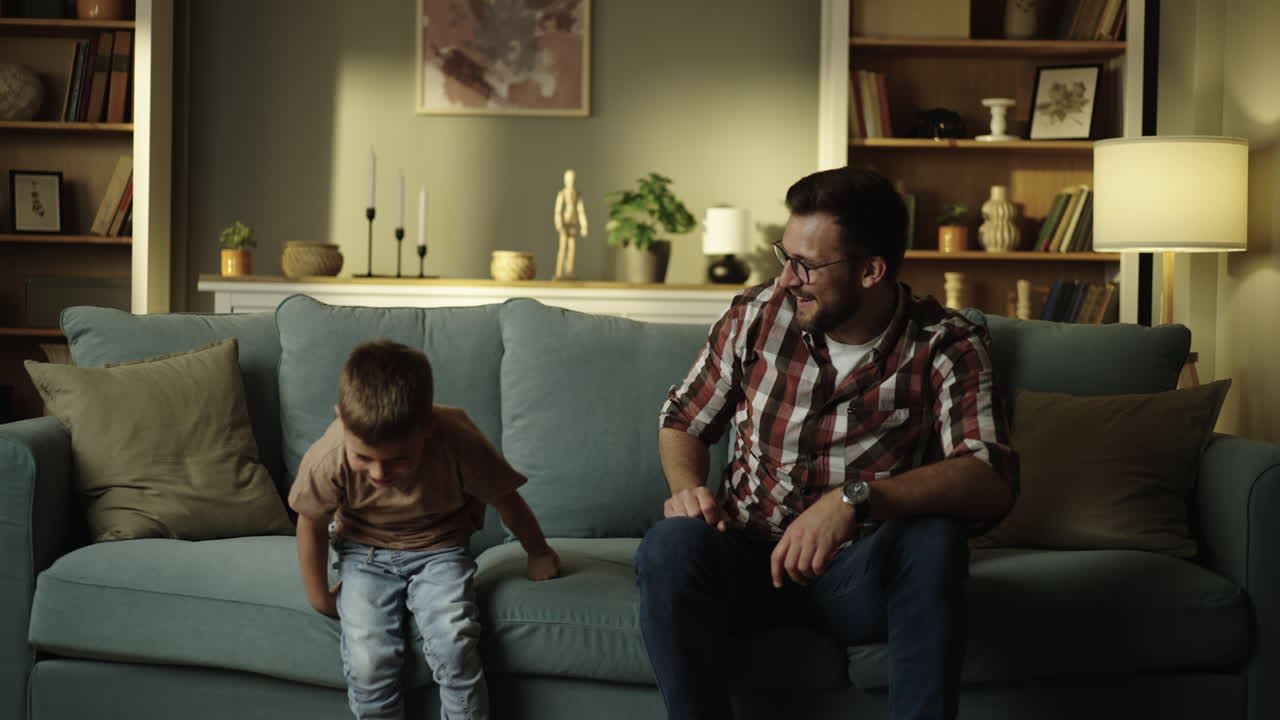Father and son relaxing on the couch at home
