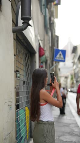 teenage girl taking photos in florence, italy