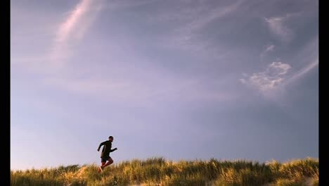 african american male runner jogging on the beach 4k