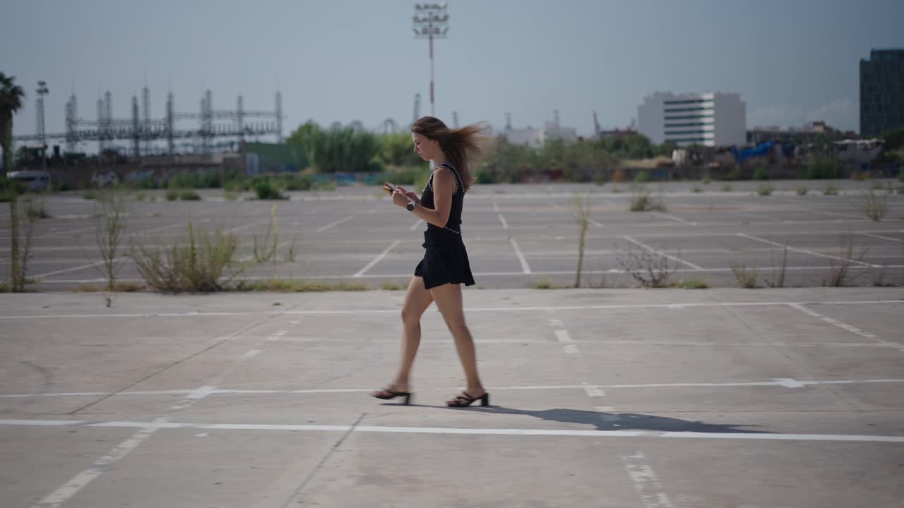 Woman Walking in an Urban Parking Lot