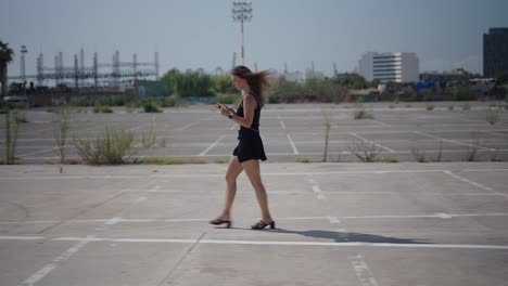 woman walking in an urban parking lot