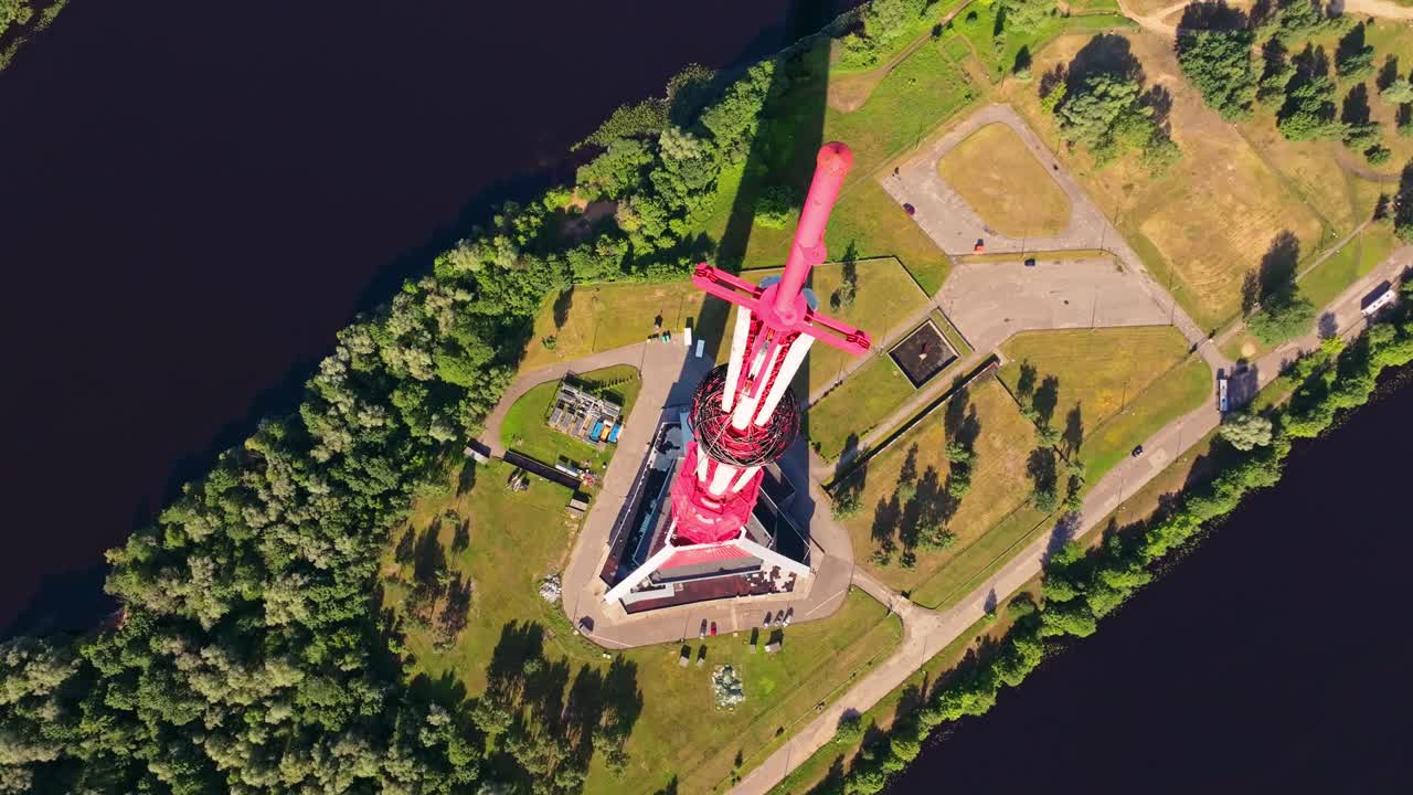 Unique top-down drone view highlights vibrant red Riga TV Tower in full sun