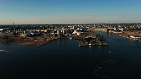 Aerial-view-approaching-the-west-side-of-Helsinki,-summer-evening-in-Finland