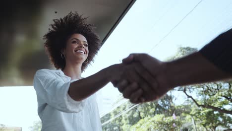 businessman and woman shake hands like hello in office closeup. cinematic 4k