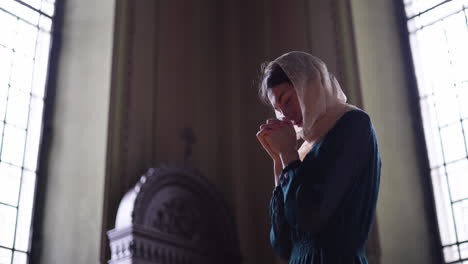 woman praying at the church