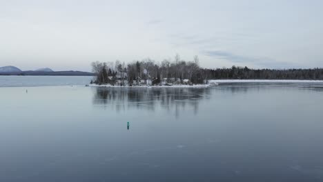 Island-on-frozen-lake-Landscape-Aerial-4K