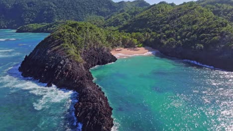 Empty-sand-beach,-beautiful-exotic-lagoon-surrounded-by-rocks-and-endless-forest