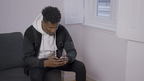 portrait of concentrated african american man texting message