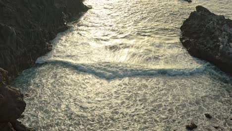 small waves crashing in a rocky cove in tenerife, los gigantes