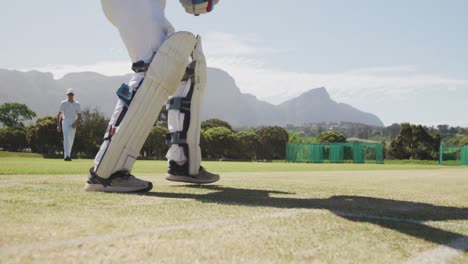 Cricket-player-stopping-the-ball-in-a-pitch